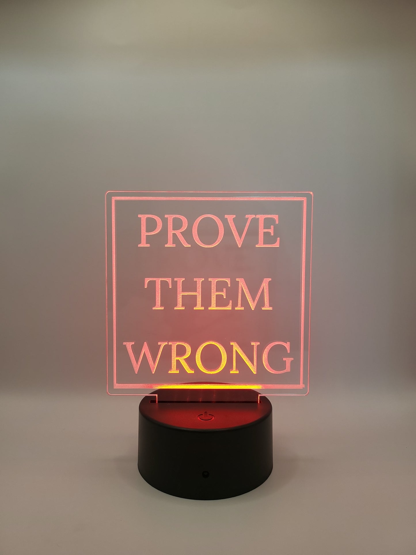 Motivational acrylic sign, with color-changing light base.